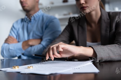 Preview: partial view of couple at table with divorce documents