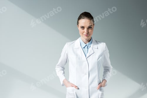 Preview: Confident Woman in Lab Coat Looking at Camera