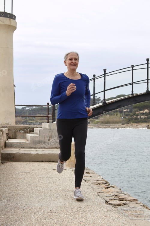 Preview: Mature woman exercising, running, outdoors