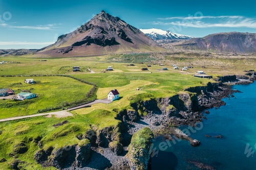 Preview: Arnarstapi fishing village with Stapafell mountain and basalt rocks on coastline at Iceland