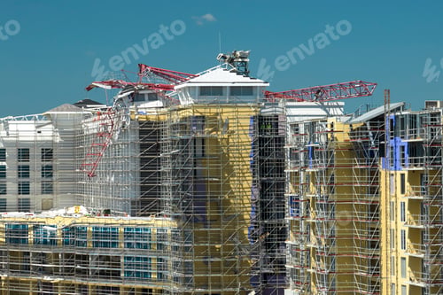 Preview: Aerial view of ruined by hurricane Ian construction crane on high apartment building site