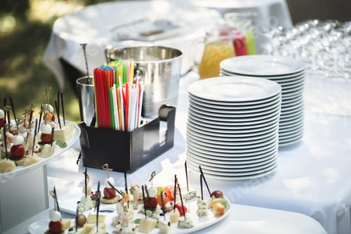 Preview: Outdoor catering banquet in summer. Table with snacks, canapes and fruits at a summer banquet
