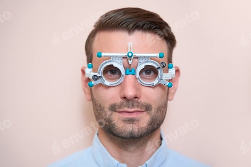 Preview: Confident male doing check up his visual acuity with special equipments