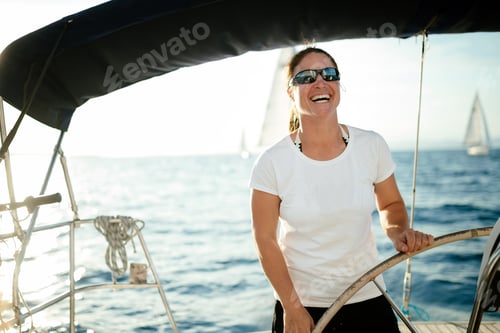 Preview: Attractive strong woman sailing with her boat