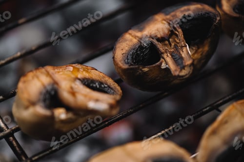 Preview: selective focus of delicious mushrooms grilling on barbecue grid