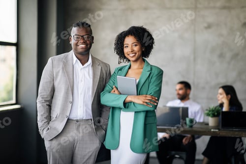 Preview: Happy Couple Of Black Coworkers Posing At Modern Office Interior