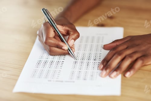 Preview: Taking a test. Shot of a person filling in an answer sheet for a test.