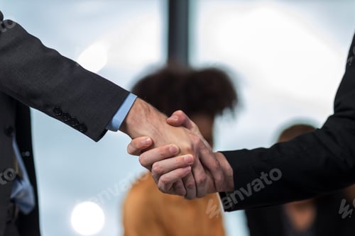 Preview: Business people shaking hands.