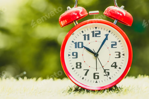 Preview: Alarm clock red Classic Vintage Retro Color Tone on Wood Table with Sun Light