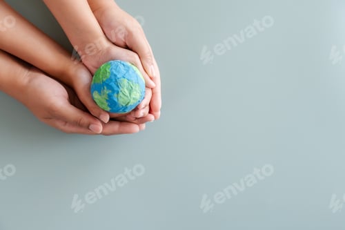 Preview: Hands holding earth paper and water paint. Concept of sustainability environment protection