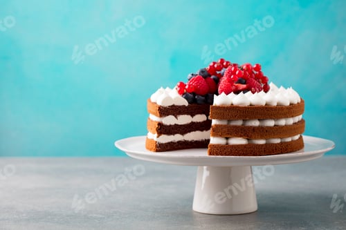 Preview: Chocolate cake with whipped cream and fresh berries. Blue background. Copy space.