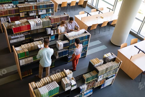 Preview: Happy group of success students studying and working together in a college library