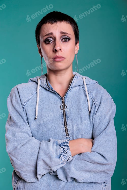 Preview: Portrait of brunette woman standing over isolated background having sad and depressed expression