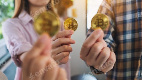 Preview: Closeup image of a group of people holding and showing golden color bitcoins in hands