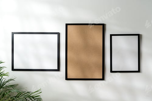 Preview: Blank picture frames on the white wall copy space