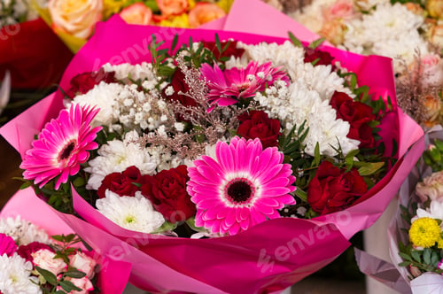 Preview: Mixed colorful flowers background. Vibrant colors of gerbera, tulips mix of summer flowers bouquet