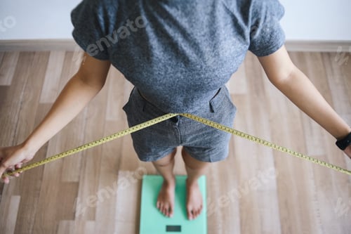 Preview: Slim Woman Weighing Body and Measure Waist Using Scale.