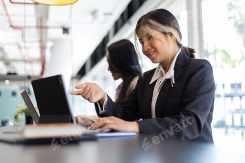 Preview: Two receptionists work at the counter.