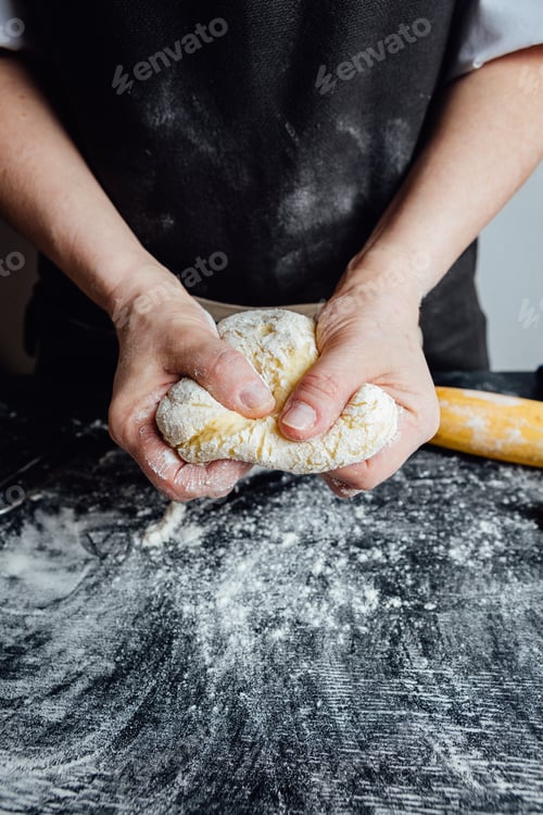 Preview: Person covering pastry with flour