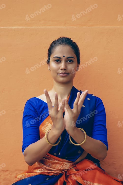 Preview: Portrait of a south Asian yogini in a sari doing asana in an ancient temple.