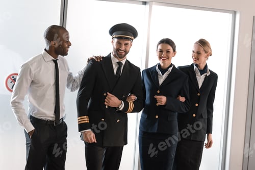 Preview: happy aviation personnel team in professional uniform