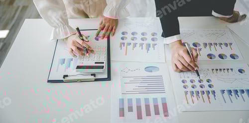 Preview: Teamwork with price chart analyzes business people on the table at the conference room.