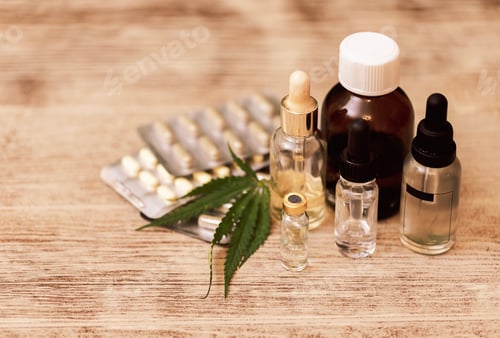 Preview: Mockups of medicines on a beige background with cannabis leaves.