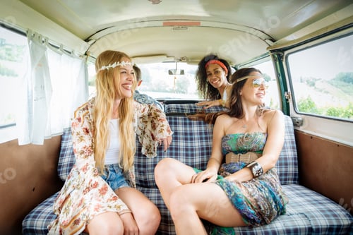 Preview: Happy friends driving a vintage minivan