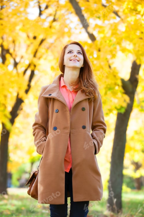 Preview: Redhead girl in autumn park