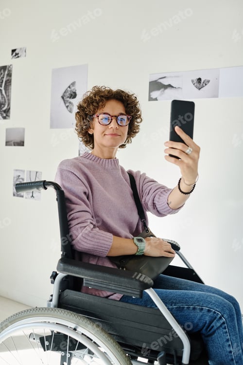 Preview: Woman with disability taking selfie on smartphone