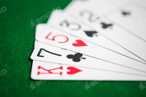 Preview: poker hand of playing cards on green casino cloth