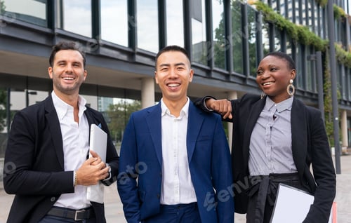 Preview: Multiethnic colleagues discussing business plan at street