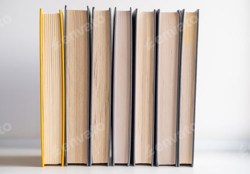 Preview: Stack of books on a white background. One book is yellow.