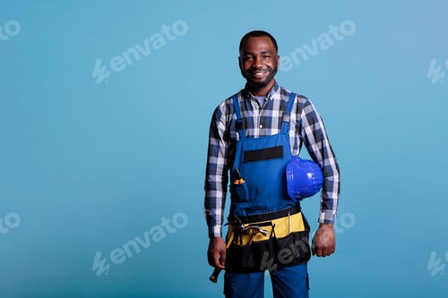 Preview: Happy construction worker holding hard hat