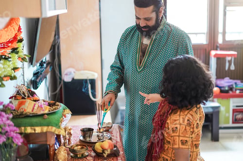 Preview: Father and son celebrating Diwali or hindu festival at home - Focus on man face