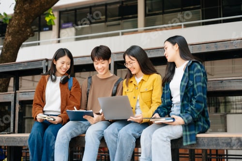 Preview: Young Asian People college students and a female student group work at the campus park in morning