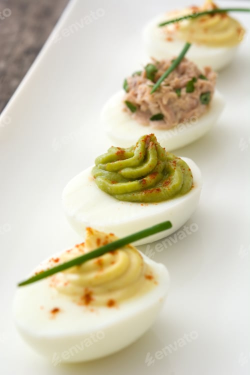 Deviled Eggs with Various Toppings on Platter