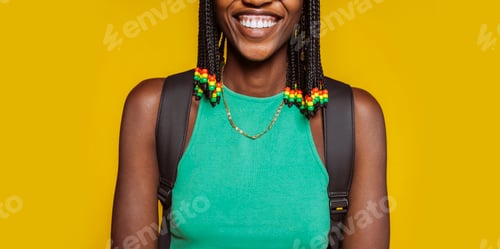 Preview: Smiling young african american woman over yellow background