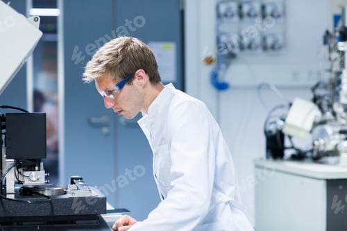 Preview: Scientist meticulously operating lab equipment.