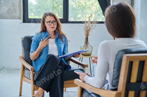 Preview: Female mental health professional working with young woman