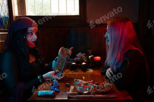 Preview: Fortune teller reading tarot cards to client in mystical atmosphere