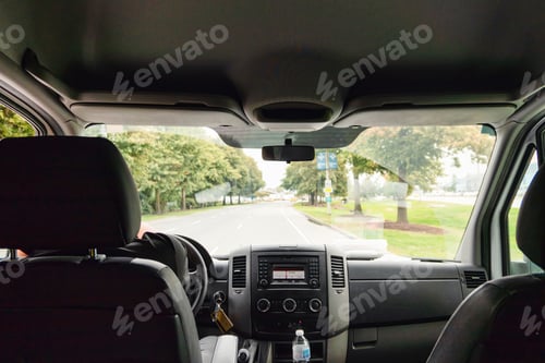 Preview: Inside of car with display panel and windscreen on the road