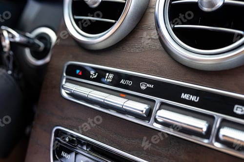 Preview: The interior of a modern passenger car with three vents visible and air conditioning control.