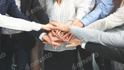 Preview: Business team stacking hands in unity, cropped