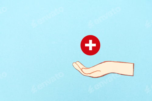 Preview: Hand holding a red medical cross symbol on a blue background