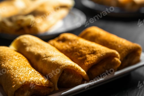 Preview: Maslenitsa traditions, stuffed pancakes rolled into a roll, close-up