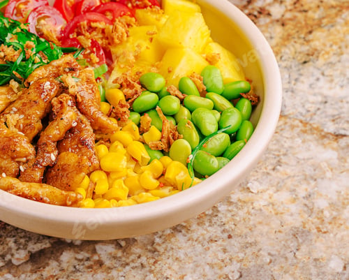 Preview: Colorful bowl of fresh ingredients with chicken on a granite countertop
