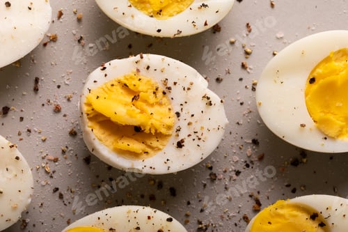 Preview: Overhead close-up view of fresh boiled white eggs with peppercorn seasoning