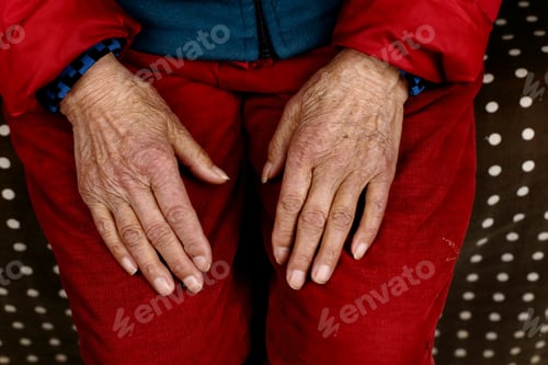 Preview: Closeup shot of an elderly Chinese female sitting with hands on her knees