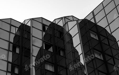 Preview: Grayscale of an exterior view of a modern business building featuring large window